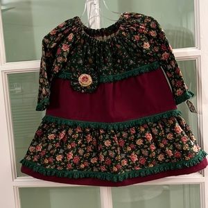 Handmade infant girls’ three tiered flannel dress in a size 18 months.